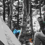 Woman sitting by tent